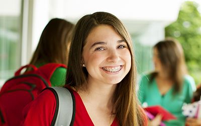 A teenage girl smiling with braces