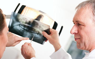 A dentist explaining an x-ray to a patient