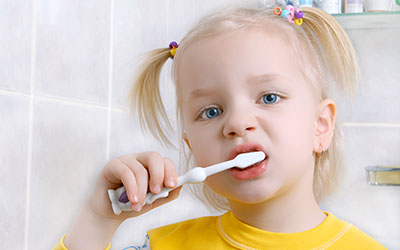 Child girl brushing teeth