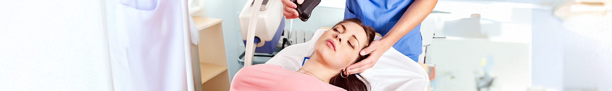 Woman in dental chair falling asleep to sedation treatment.