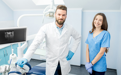 Male dentist and female assistant
