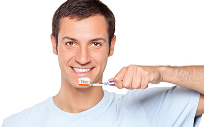 Young man brushing teeth