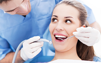 A woman having a dentist work on her teeth