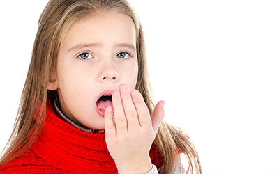 A young girl checking her breath