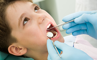 A young boy having his teeth worked on